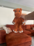 orange crochet hippo in front of orange blurred couch