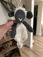 a crochet grey and white lamb with a blanket style body